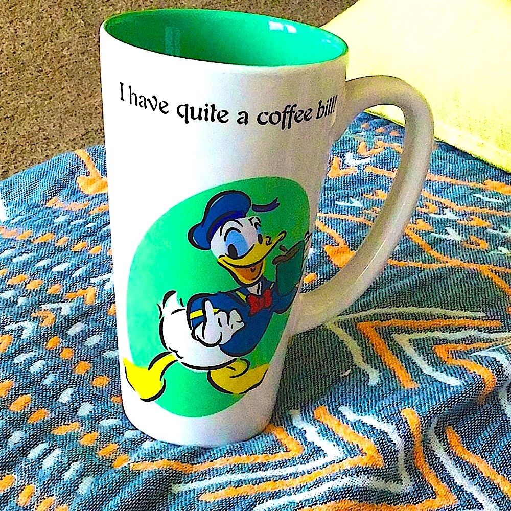 VINTAGE DONALD DUCK TALL MUG.  NEVER USED. EC. Graphics are clear and bright.